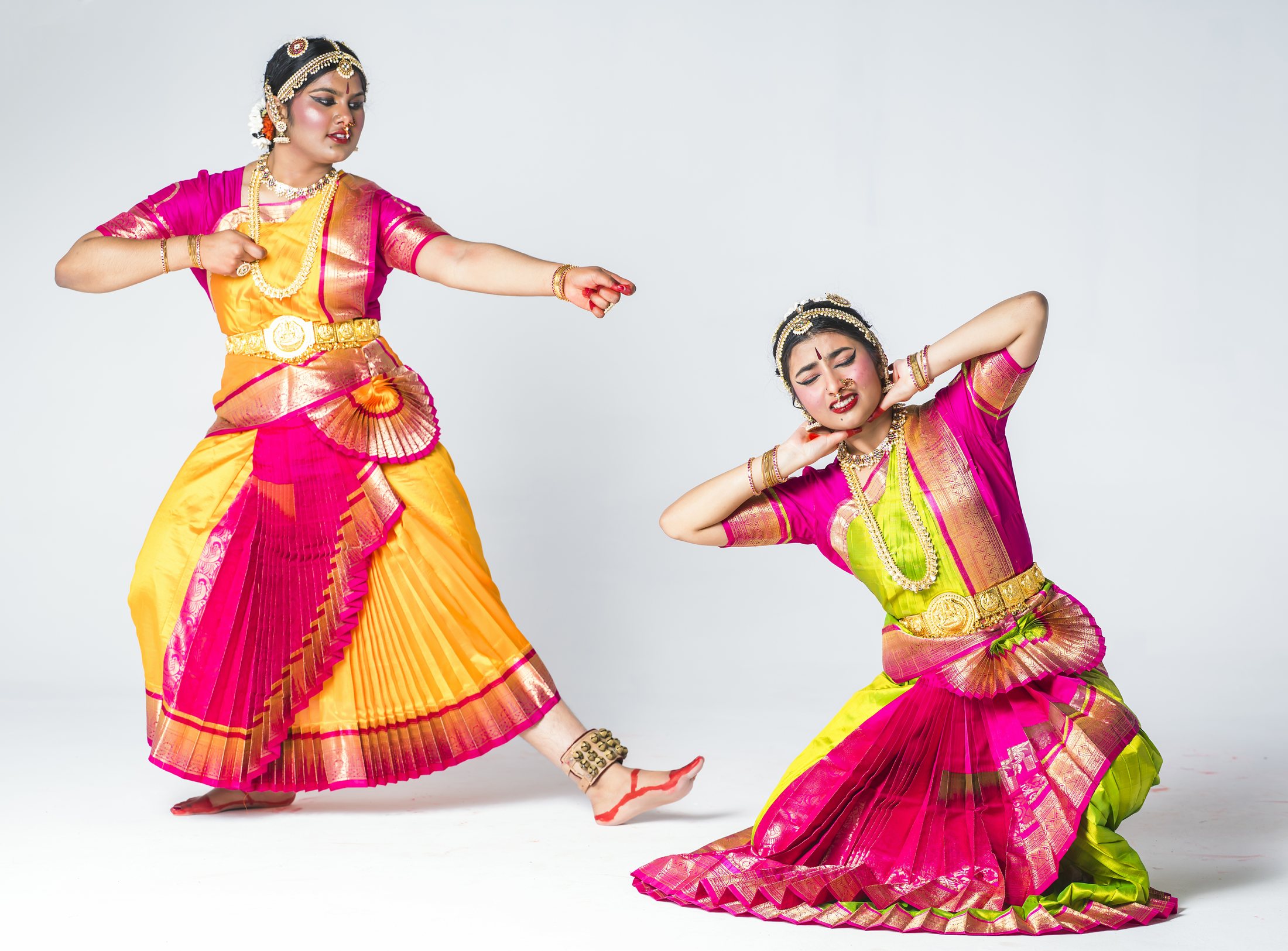Aadhya and Thanvi in pink and yellow costumes